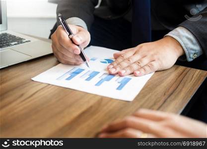 Business man analysed report of profit finance data graph document in his office