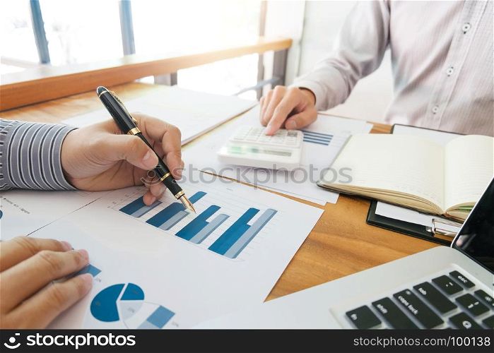 Business man analysis data document with accountant calculating about fee tax at a office
