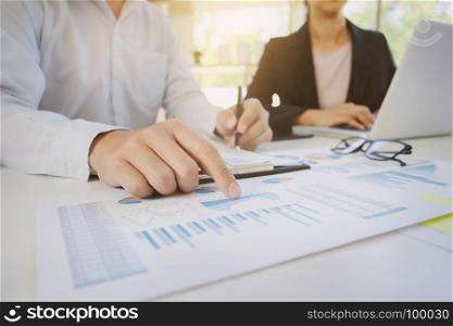 Business man analysis data document with accountant using calculator