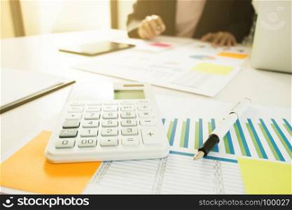 Business man analysis data document with accountant using calculator, selective focus