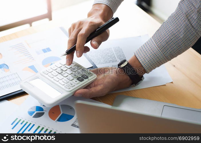 Business man analysis investment perform data document and calculating a valuation number