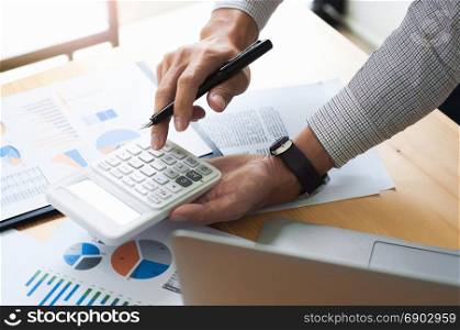 Business man analysis investment perform data document and calculating a valuation number
