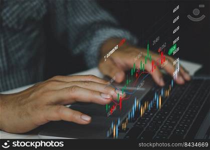 Business man analysis stock market candlestick  and economic financial investments  graphs at  laptop computer.