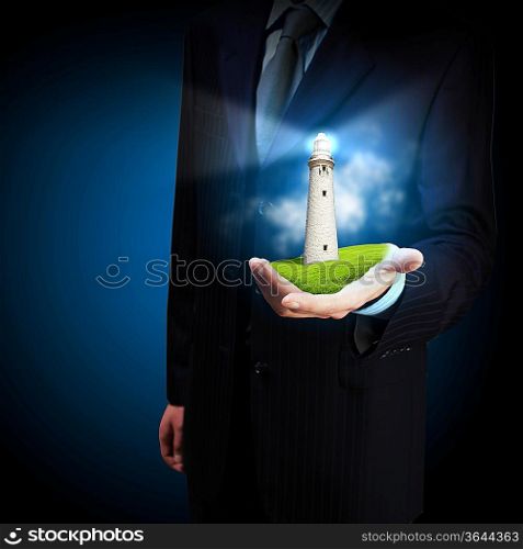 Business man and a lighthouse shining in darkness