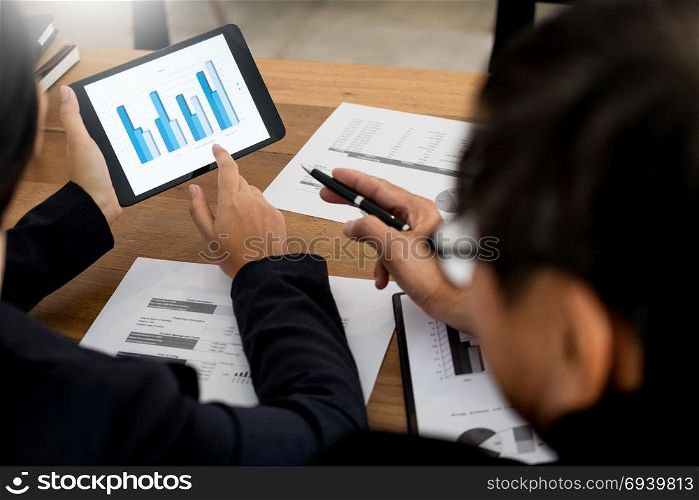 Business man and woman discuss about the financial plan on digital tablet at the modern office, Audit concept