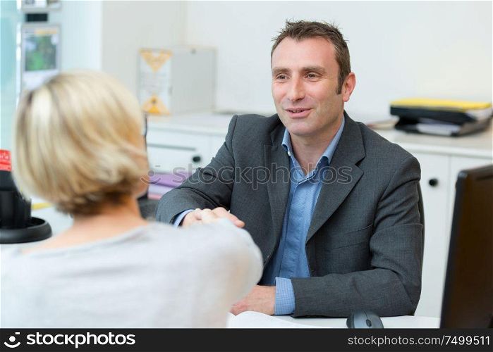 business man and woman handshake at office