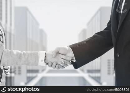 business man and woman handshake on successful meeting at rack server room closeup