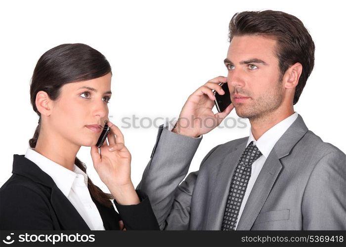 Business man and woman using cellphones