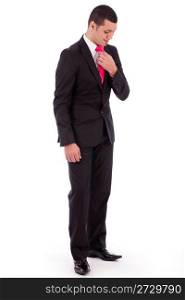 Business man bending his head down to fit his necktie on a isolated white background
