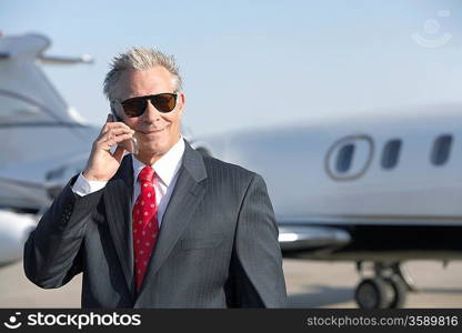 Business Man Beside an Airplane