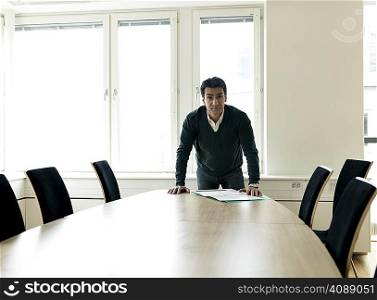 Business man by conference table