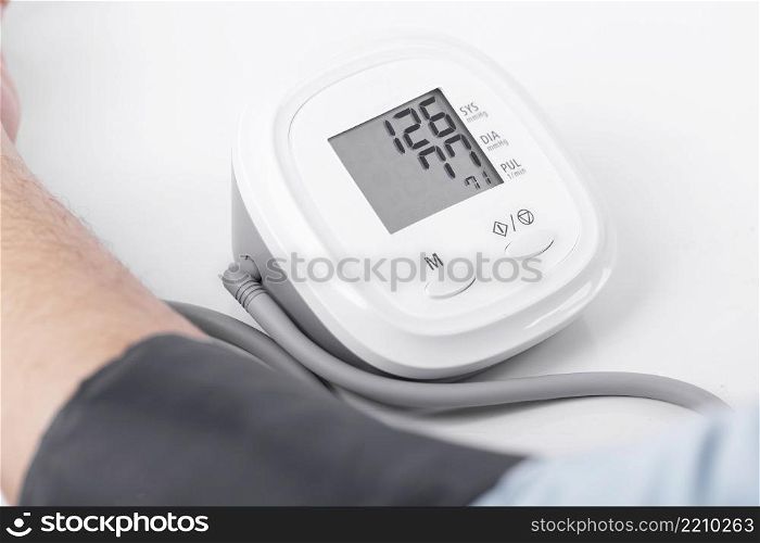 Business man check blood pressure and heart rate with Blood pressure gauge on white background , Health and Medical concept