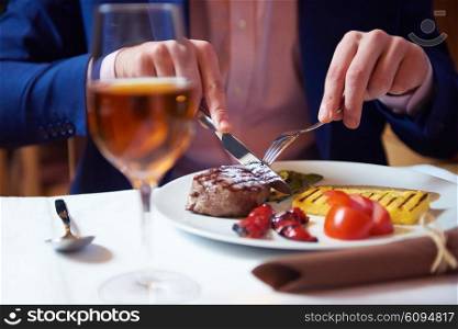 business man eating tasty beef stak at restaurant