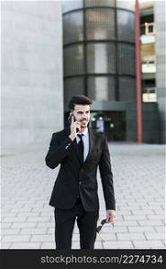 business man front office building using his mobile phone