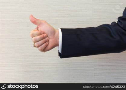 Business man gesturing the thumbs up sign.