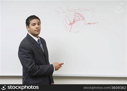 Business man giving presentation standing at whiteboard