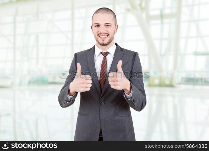 business man going thumbs up at the office