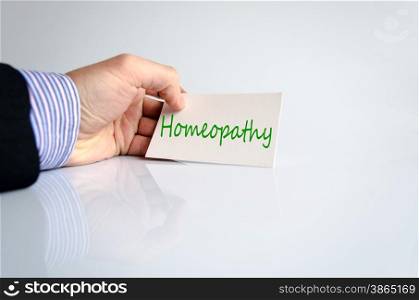 Business man hand and note homeopathy concept