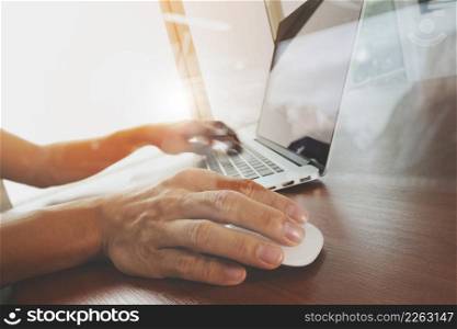 business man hand working on blank screen laptop computer on wooden desk as concept