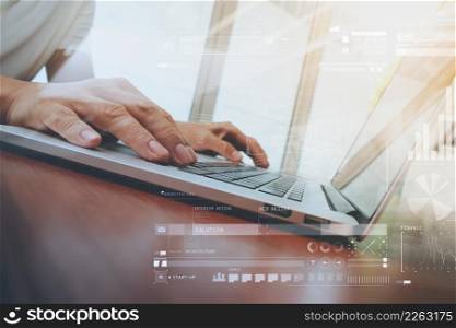 business man hand working on laptop computer with social media diagram on wooden desk as concept