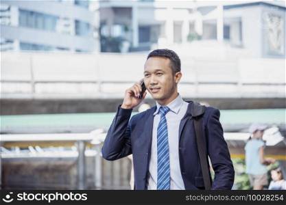 Business Man hands holding mobile phone outdoor surfing internet online technology lifestyle in city street. Entrepreneur young man in business suit hand using smartphone gadget text message lifestyle