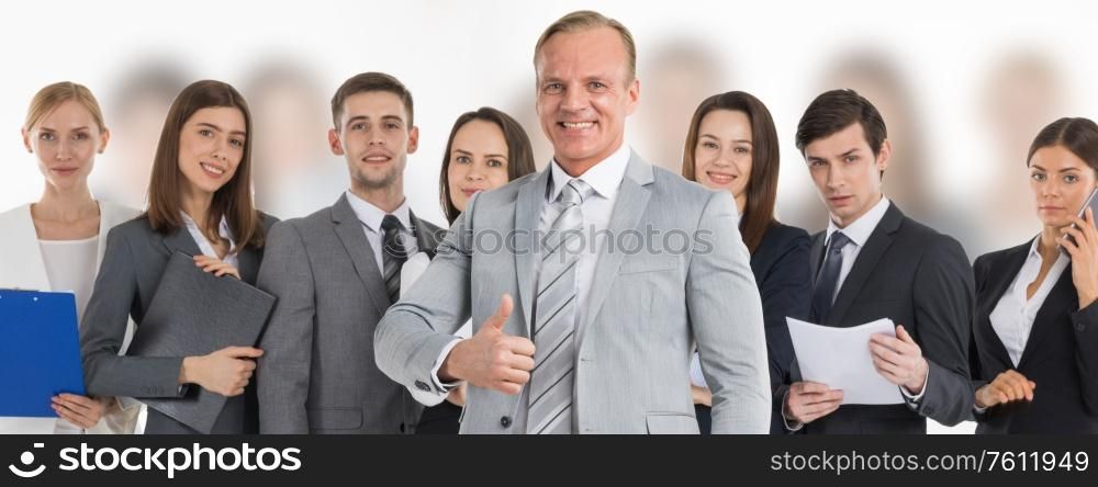 Business man hold hand with thumb up gesture, business man excited happy smile over group of businesspeople team background. Business leader and team