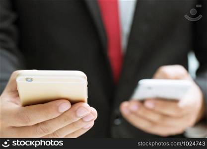 business man hold two hand using mobile phone or smartphone transfer data information. concept businessman using digital gadgets technology.