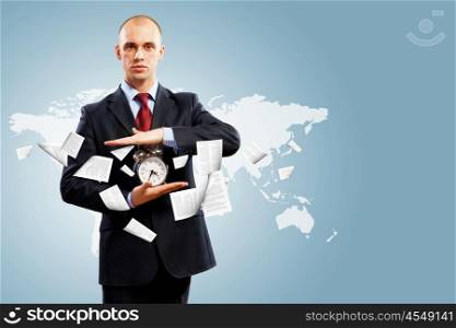 Business man holding alarmclock. Image of businessman holding alarmclock against illustration background. Collage