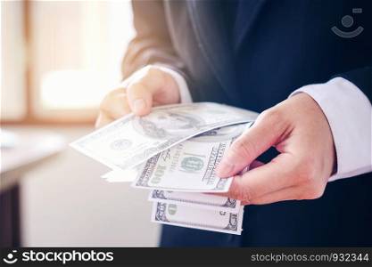 Business man holding dollar bills