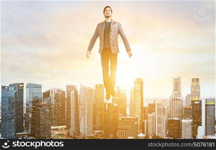 Business man hover over city skyline. Businessman hovering over down town on sunset.