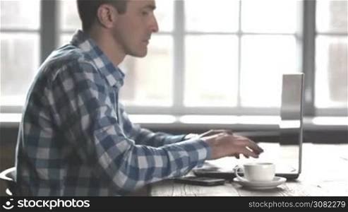Business man in casual clothes working on computer laptop and drinking coffe
