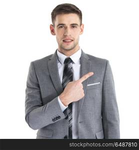 Business man in suit pointing aside. Portrait of young business man in suit pointing aside at copy space over white background