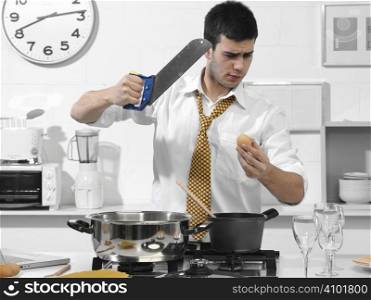 business man in the kitchen cutting an egg with a saw