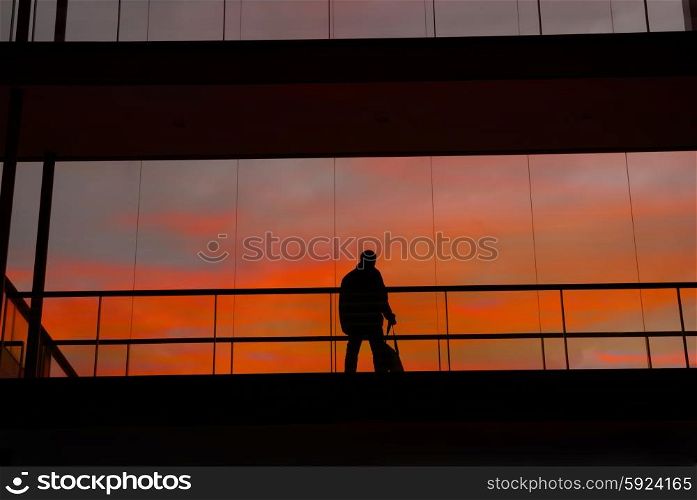 business man in the modern buildind at sunset