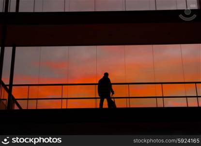 business man in the modern buildind at sunset