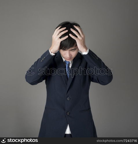 Business man is headache ,grey background in studio