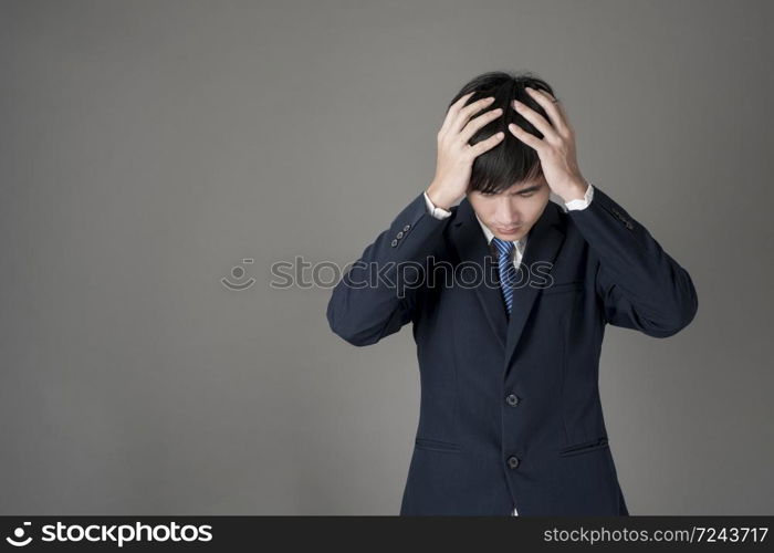 Business man is headache ,grey background in studio
