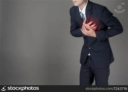 Business man is heart attack ,grey background in studio