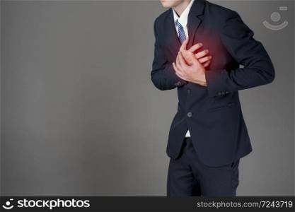 Business man is heart attack ,grey background in studio