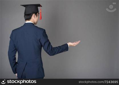 business man is holding graduation hat, business education concept