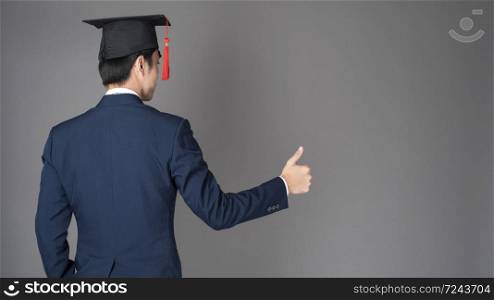 business man is holding graduation hat, business education concept