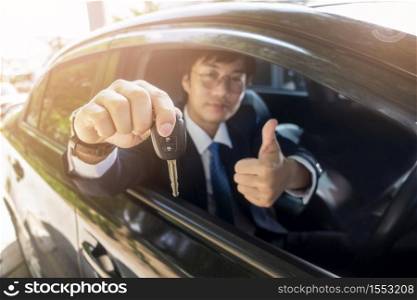 Business man is holding key car in the car