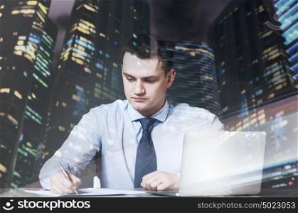business man is sitting and working documents at his table with laptop. business man with laptop