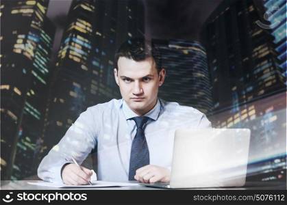 business man is sitting and working documents at his table with laptop. business man with laptop
