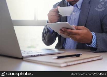 business man is using laptop in coffee shop sitting at a table