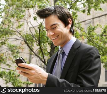 Business man laughing at his phone
