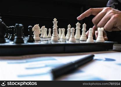 Business man leadership playing chess board, Risk and strategy, investment concept.