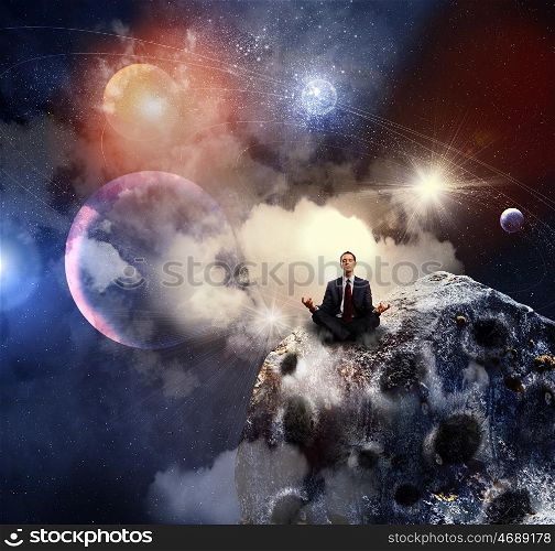 business man meditating. Businessman sitting in lotus flower position against space background