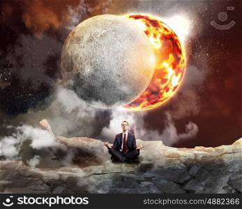 business man meditating. Businessman sitting in lotus flower position against space background