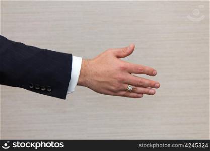 Business man offering a handshake.